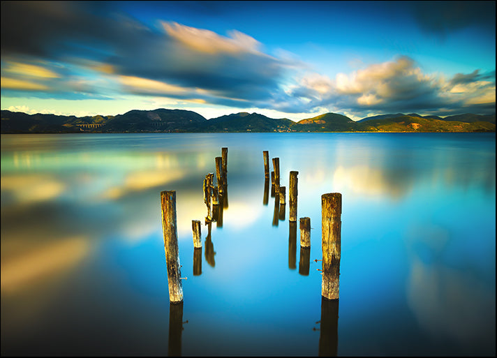 117434924 Wooden jetty remains on blue lake sunset, Versilia Massaciuccoli Tuscany Italy, available in multiple sizes